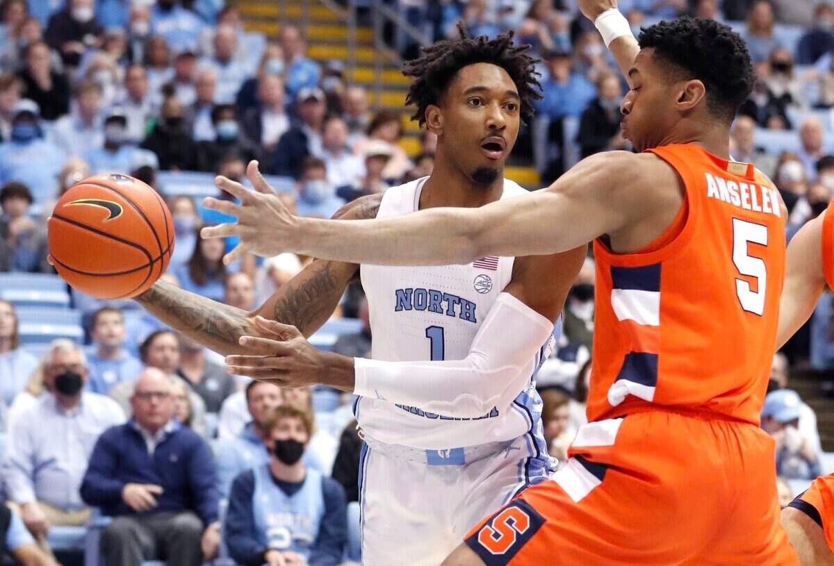 North Carolina’s Leaky Black (1) passes around the pressure by Syracuse’s Frank Anselem (5) during the first half of UNCs game against Syracuse at the Smith Center in Chapel Hill, N.C., Monday, Feb. 28, 2022.