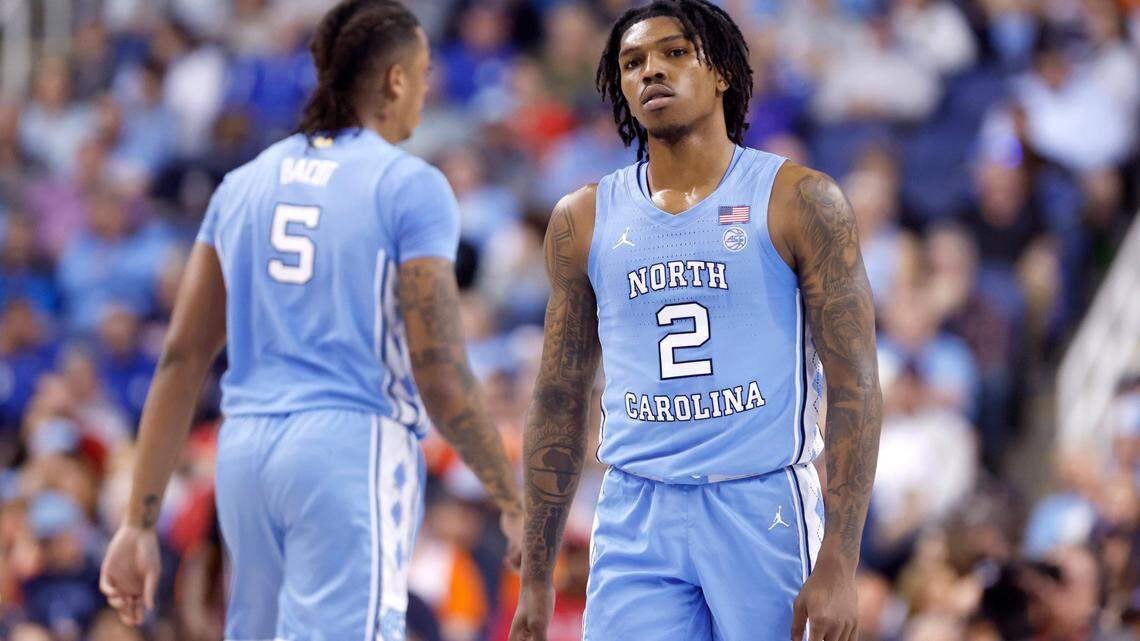 North Carolina’s Caleb Love (2) and Armando Bacot (5) walk back on the court after a timeout during the first half of UNC’s game against Virginia in the quarterfinals of the ACC Men’s Basketball Tournament in Greensboro, N.C., Thursday, March 9, 2023.