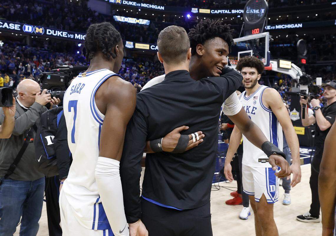 Duke head coach Jon Scheyer hugs Patrick Ngongba II (21) after Duke’s 68-63 victory over Michigan in the Capital Showcase at Capital One Arena in Washington, D.C., Saturday, Feb. 21, 2026.