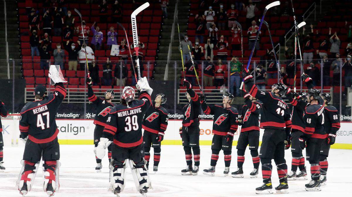 The Carolina Hurricanes salute the fans, who returned to PNC Arena for the first time this season, after a win over the Detroit Red Wings in an NHL hockey game in Raleigh, N.C., Thursday, March 4, 2021. AP Photo/Chris Seward)