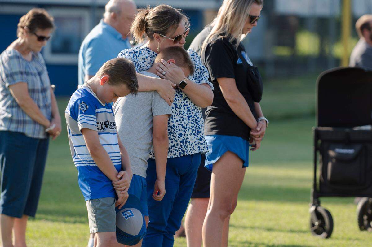 Before that evening’s baseball game, Garner Baseball Inc. held a vigil for Miles Campbell and his parents Tyler and Susan in Garner, N.C., Tuesday, May 28, 2024. The Campbells were killed after an SUV driver ran a red light and collided with their vehicle on U.S. 70 Monday afternoon.