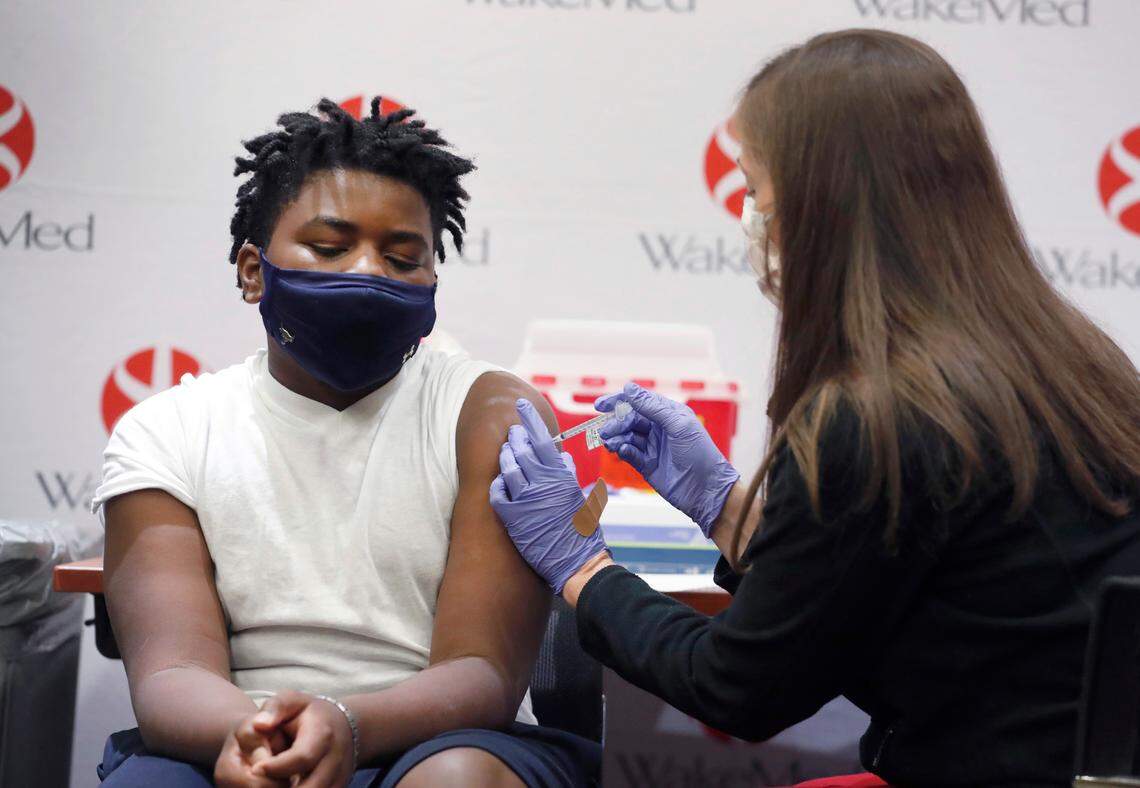 Gavin McLawhorn, 12, of Wake Forest receives his first COVID-19 vaccine shot at WakeMed Raleigh Campus on May 13, 2021.
