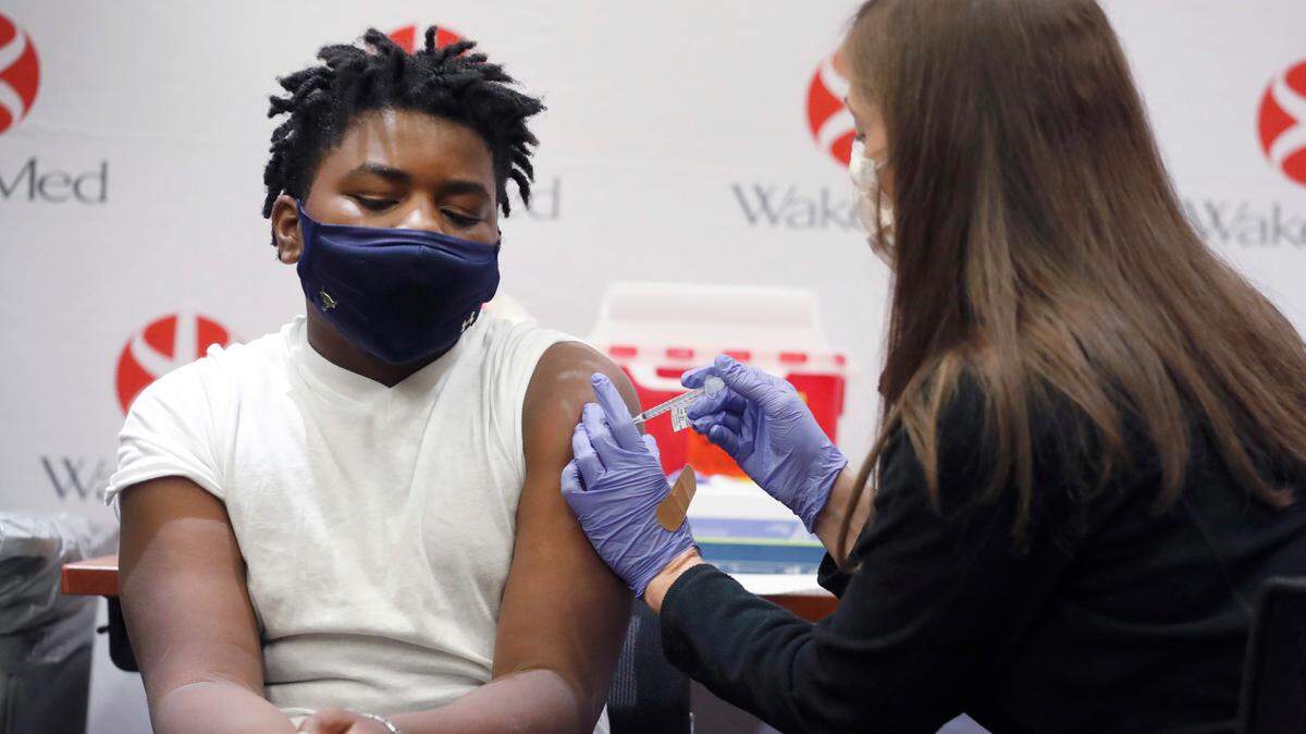 Gavin McLawhorn, 12, of Wake Forest receives his first COVID-19 vaccine shot at WakeMed Raleigh Campus on May 13, 2021. New research from Iowa State University suggests that exercising after getting the COVID-19 vaccine could boost the body’s immune response.