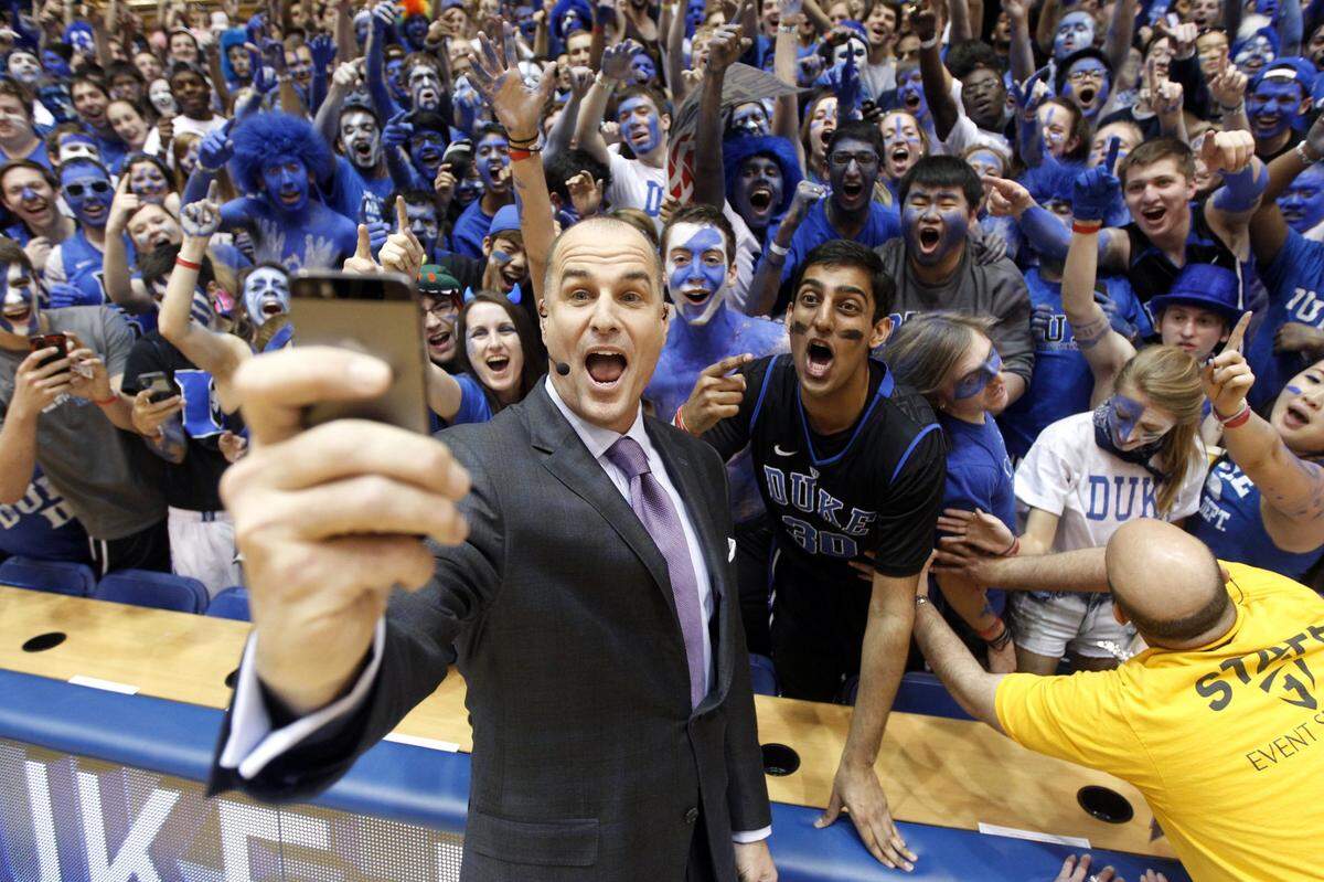ESPN basketball analyst and former Duke player Jay Bilas takes a selfie with the Cameron Crazies before Duke’s game against Syracuse at Cameron Indoor Stadium in Durham, N.C., Saturday, February 22, 2014.