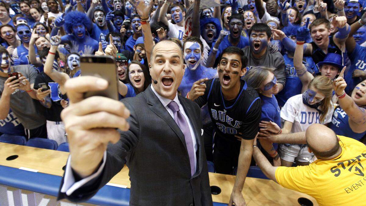 ESPN basketball analyst and former Duke player Jay Bilas takes a selfie with the Cameron Crazies before Duke’s game against Syracuse at Cameron Indoor Stadium in Durham, N.C., Saturday, February 22, 2014.