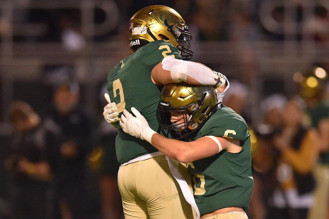 Cardinal Gibbons’ Carter Scearce (2) congratulates Oliver Evans (6) after his pass breakup during the first quarter. The Cardinal Gibbons Crusaders and the Rolesville Rams met in the NCHSAA 4A East Regional Final in Raleigh, N.C. on December 3, 2021