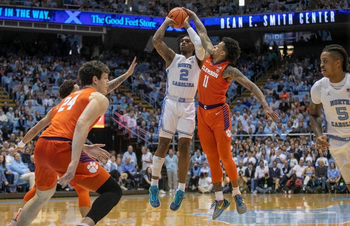 Clemson’s Brevin Galloway (11) defends North Carolina’s Caleb Love (2) in the first half on Saturday, February 11, 2023 at the Smith Center in Chapel Hill, N.C.
