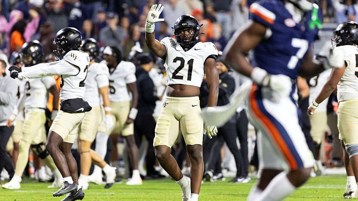 CHARLOTTESVILLE, VIRGINIA - NOVEMBER 08: Aiden Hall #21 of the Wake Forest Demon Deacons waves to the crowd at the end of the second half during a game against the Virginia Cavaliers at Scott Stadium on November 8, 2025 in Charlottesville, Virginia. (Photo by Ryan M. Kelly/Getty Images)