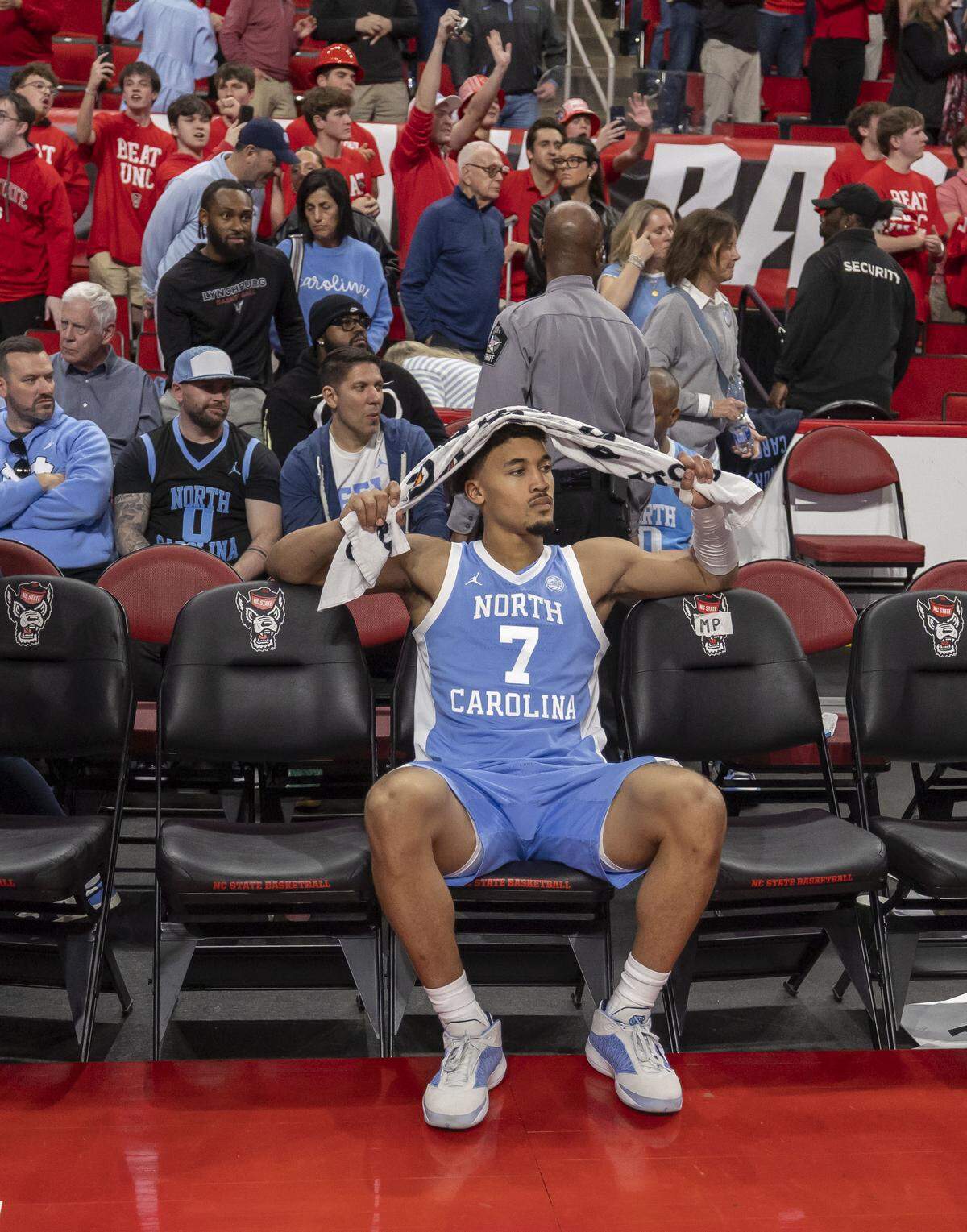 North Carolina guard Seth Trimble (7) covers his head with a towel following the Tar Heels’ 82-58 loss to N.C. State on Tuesday, February 17, 2026 at Lenovo Center in Raleigh, N.C.