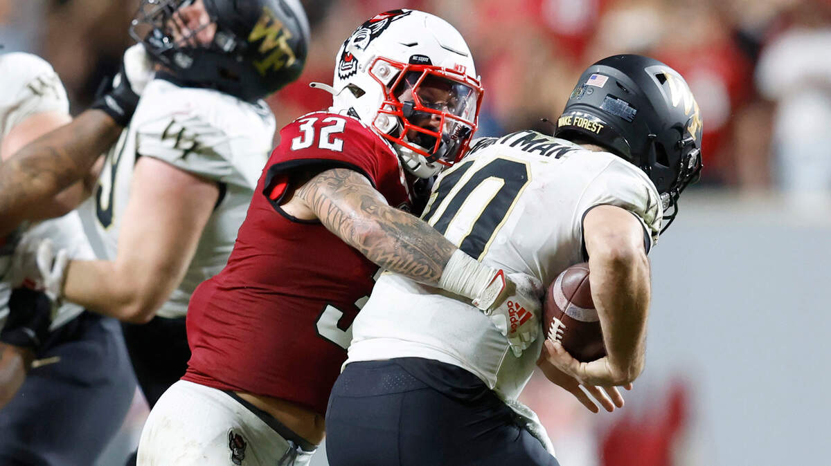 N.C. State linebacker Drake Thomas (32) sacks Wake Forest quarterback Sam Hartman (10) during the second half of N.C. State’s 30-21 victory over Wake Forest at Carter-Finley Stadium in Raleigh, N.C., Saturday, Nov. 5, 2022.