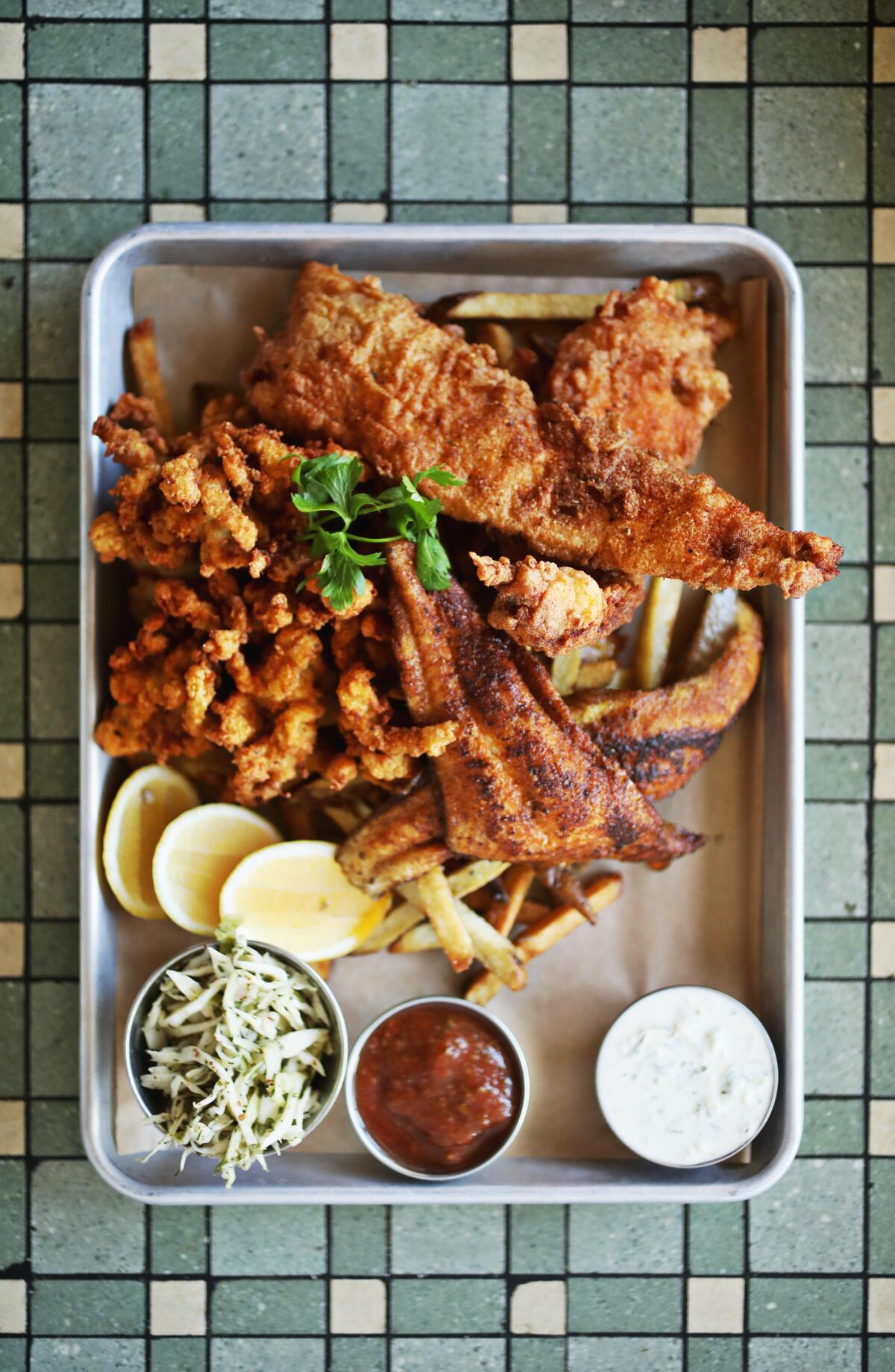 James Pharmacy’s coastal fried fish platter is made up of fried NC flounder, grilled NC catfish, fried clam strips, house-cut fries, house slaw and served with cocktail sauce and an herby house-made tartar sauce.