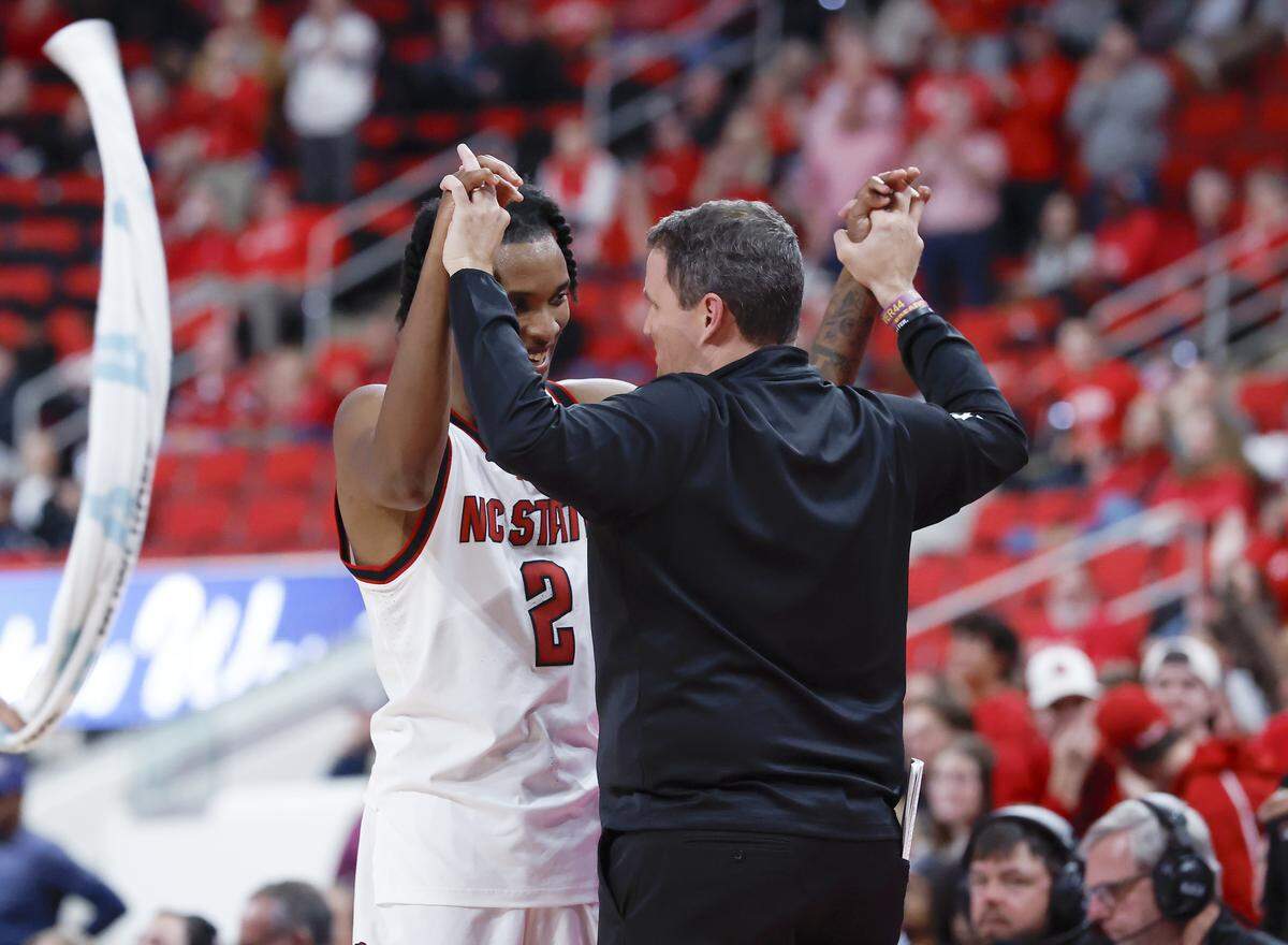 N.C. State’s Paul McNeil, Jr. high fives head coach Will Wade after exiting the game late in the second half of the Wolfpack’s 110-64 win over UNC Greensboro on Wednesday, Nov. 12, 2025, at Lenovo Center in Raleigh, N.C.