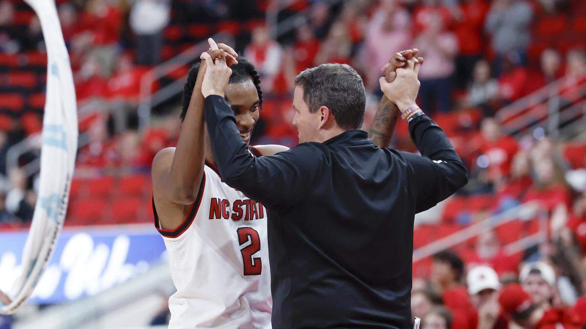 N.C. State’s Paul McNeil, Jr. high fives head coach Will Wade after exiting the game late in the second half of the Wolfpack’s 110-64 win over UNC Greensboro on Wednesday, Nov. 12, 2025, at Lenovo Center in Raleigh, N.C.