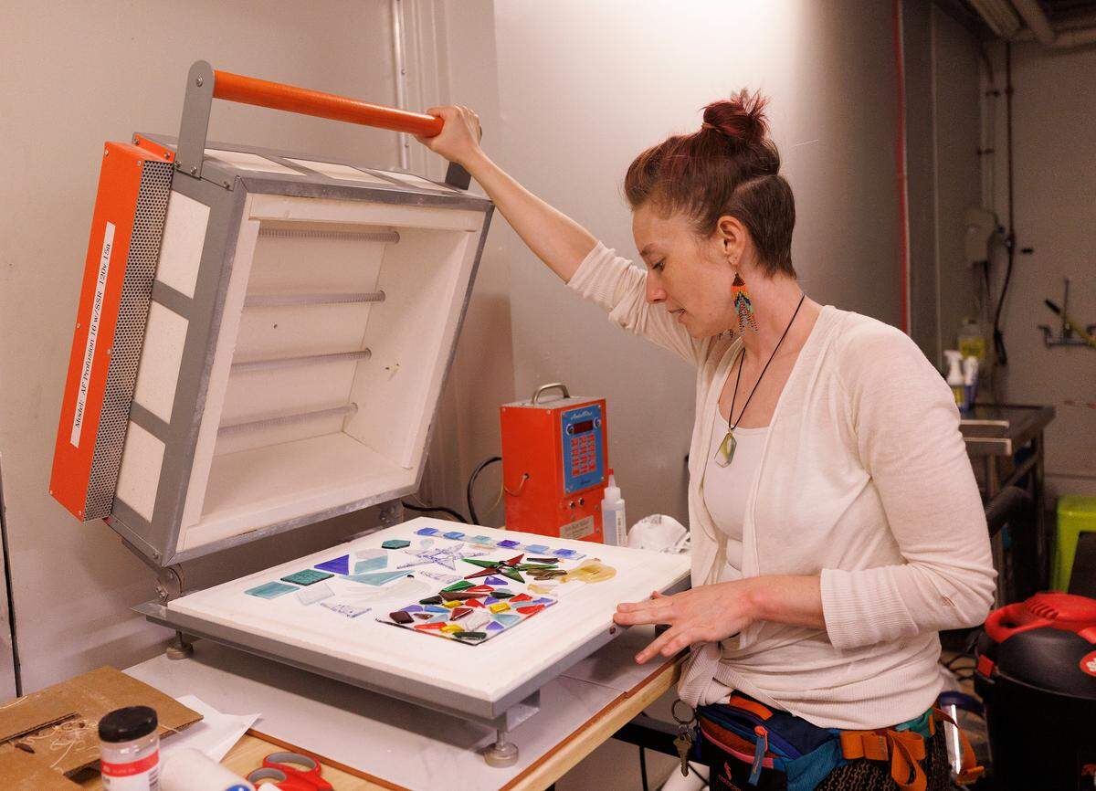 Sam Nguyen, owner of Say It With Glass, shows pieces in the kiln at her business in Carrboro, N.C. on Thursday, Nov. 7, 2024.