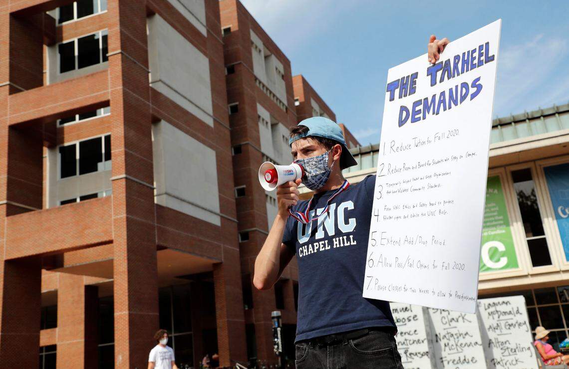 Garrett Tucker, a UNC-Chapel Hill sophomore from Charlotte, protests at “The Pit” on the campus of UNC in Chapel Hill, N.C., Tuesday, August 18, 2020. Tucker and his roommates Michael Metcalf and Adalgeovany Caceres are part of a group called The Tarheel Demands, who have a created a list of actions they would like seen taken.