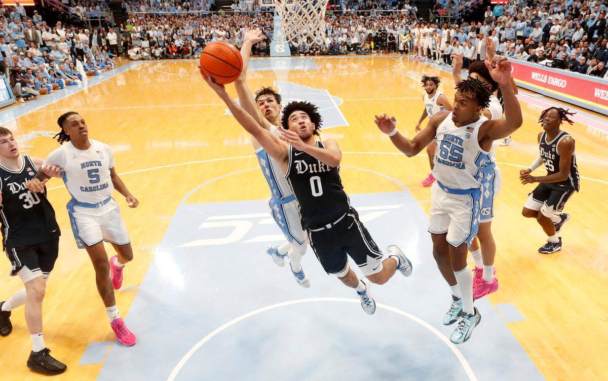 Duke’s Jared McCain (0) drives to the basket as North Carolina’s Cormac Ryan (3) defends during UNC’s 93-84 victory over Duke at the Smith Center in Chapel Hill, N.C., Saturday, Feb. 3, 2024.