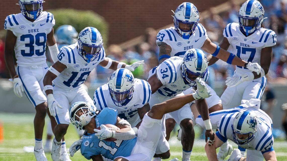 North Carolina’s Josh Downs (11) is brought down by Duke’s Shaka Heyward (42) for no gain on a punt return in the second quarter on Saturday, October 2, 2021 at Kenan Stadium in Chapel Hill, N.C.
