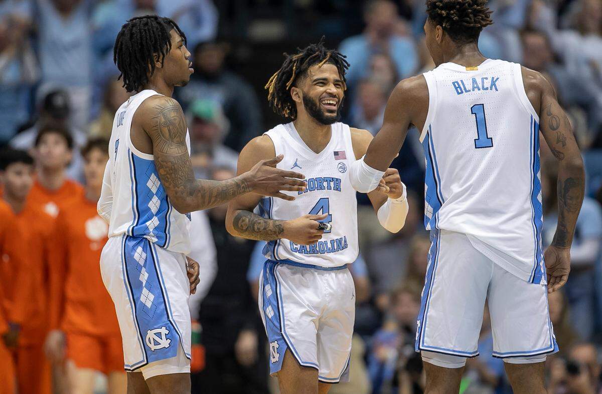 North Carolina’s R.J. Davis (4) reacts after a basket with teammates Caleb Love (2) and Leaky Black (1) in the second half against Clemson on Saturday, February 11, 2023 at the Smith Center in Chapel Hill, N.C.