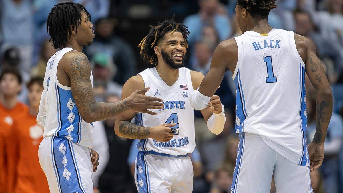North Carolina’s R.J. Davis (4) reacts after a basket with teammates Caleb Love (2) and Leaky Black (1) in the second half against Clemson on Saturday, February 11, 2023 at the Smith Center in Chapel Hill, N.C.