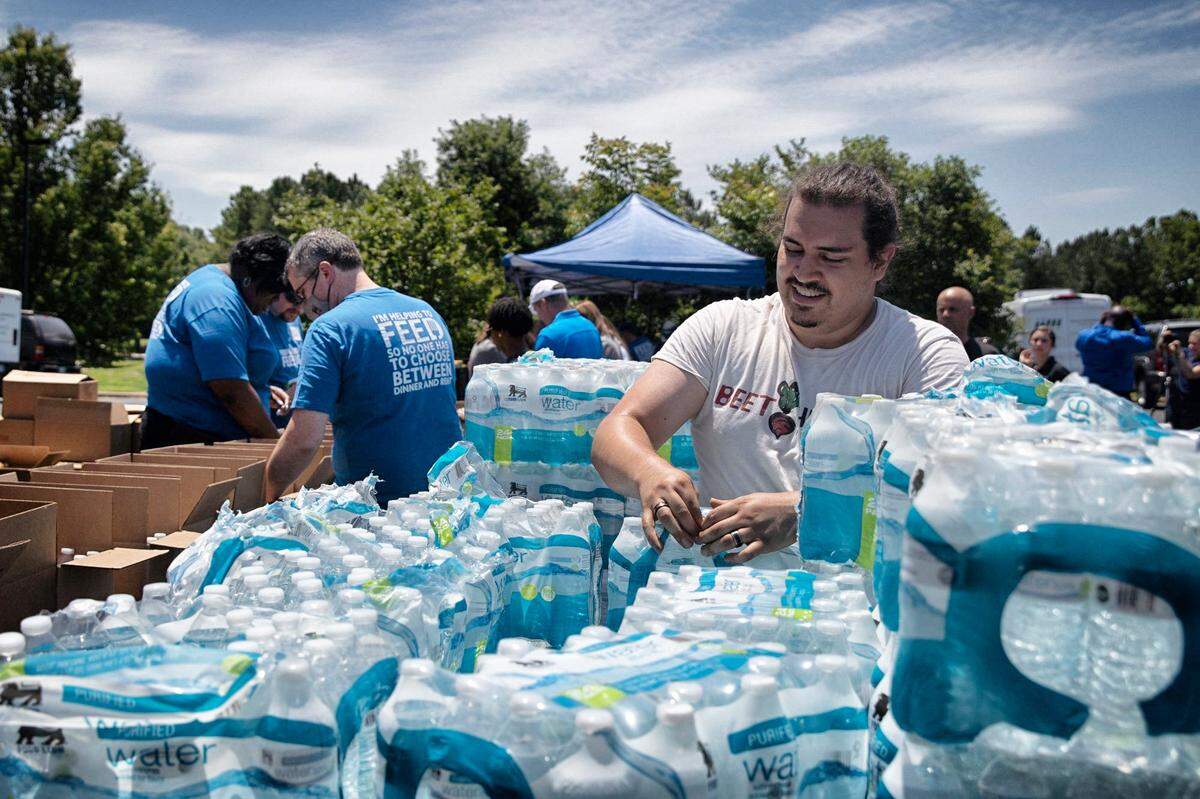 Volunteers gathered to pack 1,000 Emergency Preparedness Kits filled with food, water and other supplies to disburse to families and individuals in case of a flood or hurricane on June 18, 2021 at the Inter-faith Food Shuttle warehouse in Raleigh, N.C. The Food Shuttle, along with volunteers from Blue Cross NC and Food Lion collaborated to pack the kits.