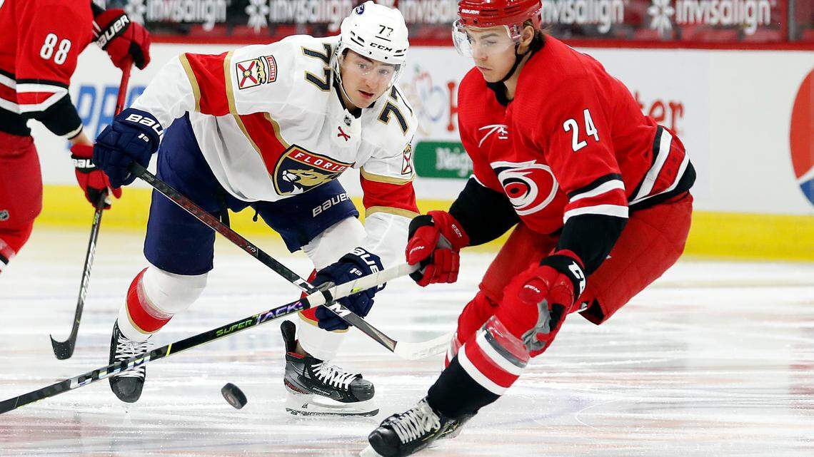 Carolina Hurricanes’ Jake Bean (24) battles with Florida Panthers’ Frank Vatrano (77) during the first period of an NHL hockey game in Raleigh, N.C., Tuesday, April 6, 2021. (AP Photo/Karl B DeBlaker)