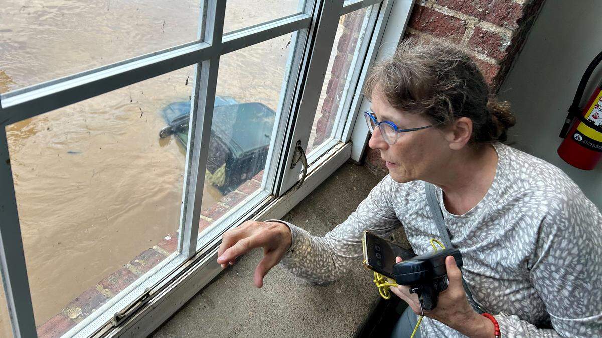 Mary Radulescu in Rivermill Apartments checks on flooding from the Haw River in Saxapahaw, N.C. following heavy rains from Chantal.