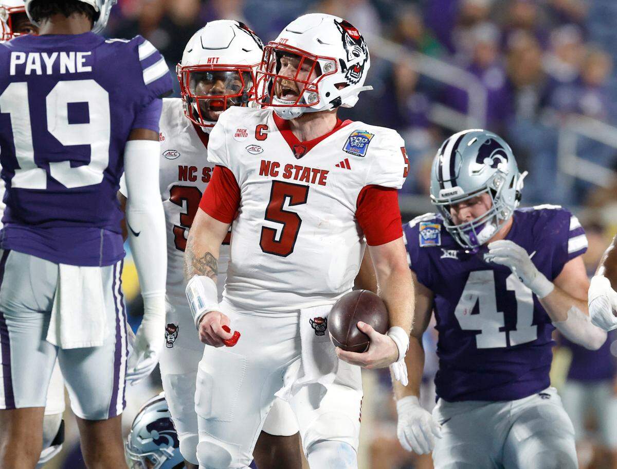 DUPLICATE***N.C. State defensive tackle C.J. Clark (5)***N.C. State quarterback Brennan Armstrong (5) celebrates after a long run during the first half of N.C. State’s game against Kansas State in the Pop-Tarts Bowl at Camping World Stadium in Orlando, Fla., Thursday, Dec. 28, 2023.