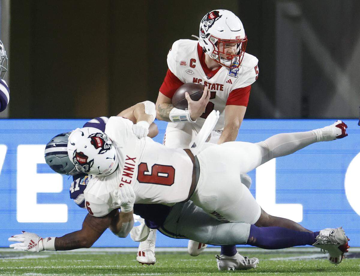 N.C. State quarterback Brennan Armstrong (5) looks for running room during the first half of N.C. State’s game against Kansas State in the Pop-Tarts Bowl at Camping World Stadium in Orlando, Fla., Thursday, Dec. 28, 2023.