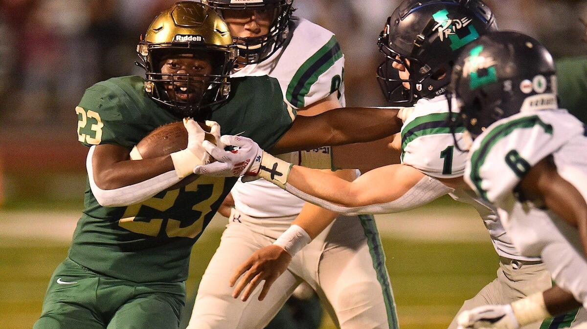 Cardinal Gibbons’ Donovan Shepard (23) stiff-arms Leesville Road’s Tyler Lassiter (1) during the first half. The Cardinal Gibbons Crusaders and the Leesville Road Pride met in a football game in Raleigh , N.C. on October 8, 2021.