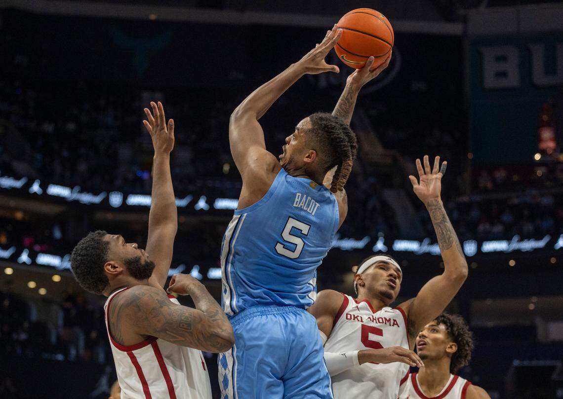 North Carolina’s Armando Bacot (5) puts up a shot over Oklahoma’s John Hugley IV (1) and Rivaldo Soares (5) in the first half on Wednesday, December 20, 2023 at the Spectrum Center in Charlotte, N.C.
