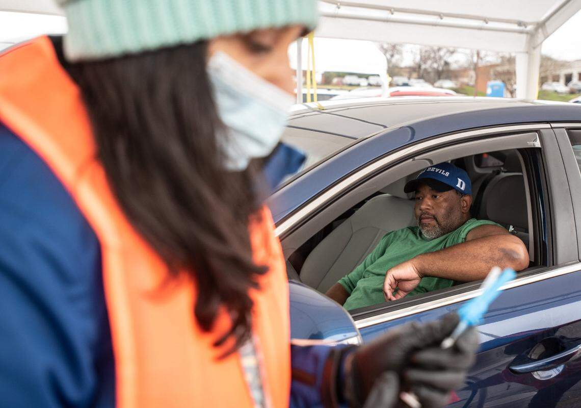 Ann Mathew (left) prepares a COVID-19 vaccine for Christopher Hartsoe in Salisbury, NC, on Wednesday, March 17, 2021.