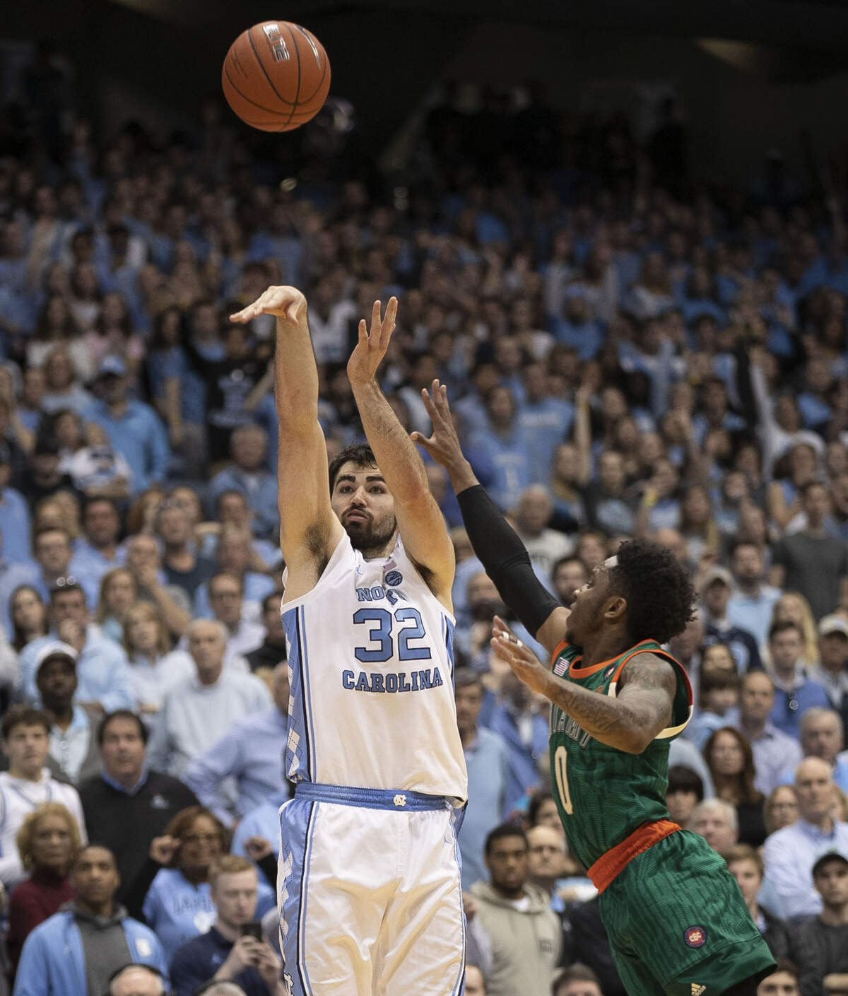 North Carolina’s Luke Maye (32) launches a three-point shot over Chris Lykes (0) with 12 seconds to play to tie the score 77-77 and force overtime on Saturday, February 9, 2019 at the Smith Center in Chapel Hill, N.C.