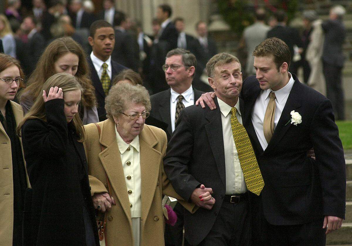 Michael Peterson, second from right, is comforted by his son after the funeral for his wife, Kathleen Peterson, Thursday at Duke Chapel.