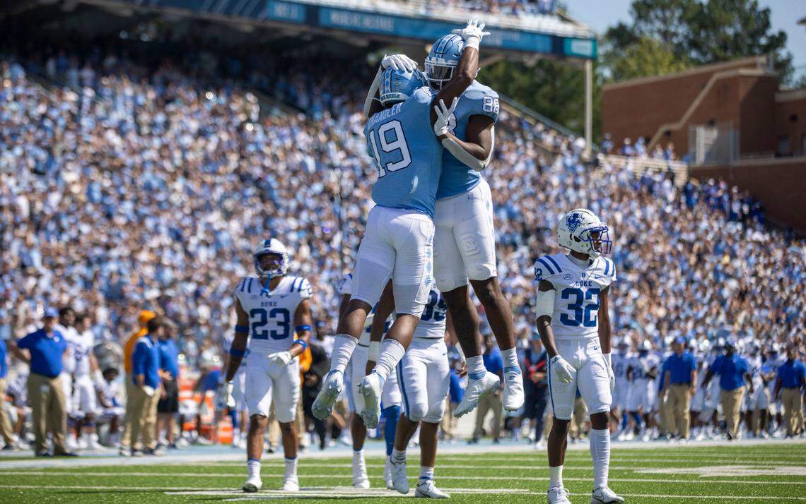 North Carolina’s Ty Chandler (29) celebrates with teammate Kamari Morales (88) after scoring on a 75-yard touchdown on a pass from quarterback Sam Howell (7) in the first quarter on Saturday, October 2, 2021 at Kenan Stadium in Chapel Hill, N.C.