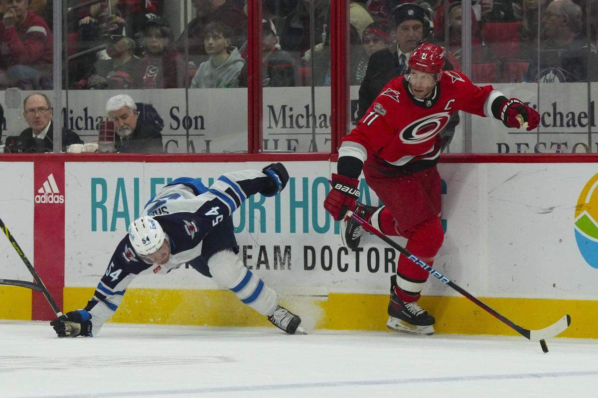 Carolina Hurricanes center Jordan Staal (11) side steps a check by Winnipeg Jets defenseman Dylan Samberg (54) during the first period at PNC Arena.