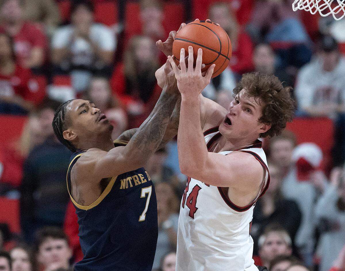 Notre Dame’s Tae Davis and N.C. State’s Ben Middlebrooks battle for a rebound during the second half of the Wolfpack’s 66-65 win on Wednesday, Jan. 8, 2025, at Lenovo Center in Raleigh, N.C.