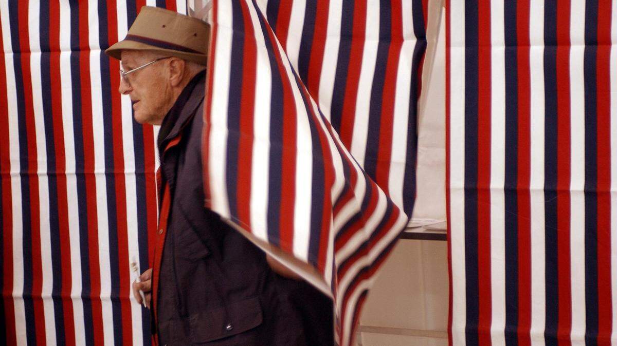 VOTE1.NE.012704.RTW--Manchester, New Hampshire--Adrian Mailhut emerges from a voting booth after casting his ballot at Parker-Varney Elementary School on Tuesday morning Jan 27, as residents of the Granite State participate in the nation’s first presidential primary stf/Robert Willett