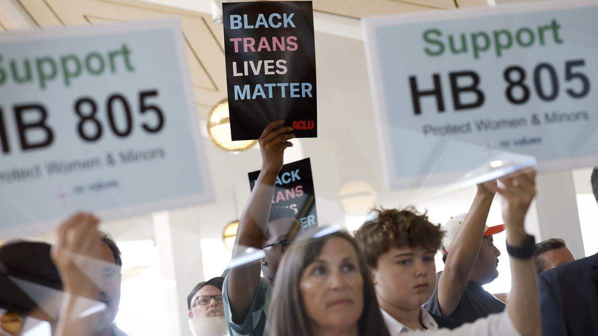 A protester holds up a sign calling for the House to allow Governor Stein’s veto of House Bill 805 among supporters of an override outside the gallery during the N.C. House session at the Legislative Building in Raleigh, N.C., Tuesday, July 29, 2025.