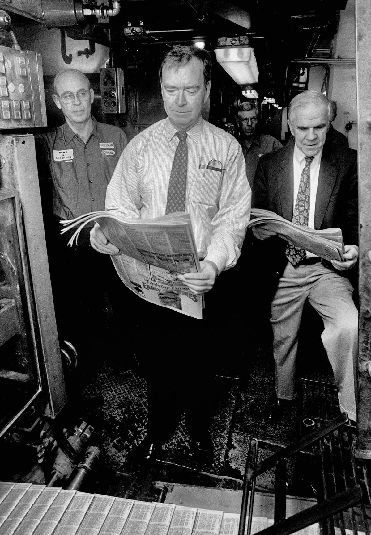 Publisher Frank Daniels Jr.and Raleigh Times Editor A.C. Snow look over the final edition of the Raleigh Times as it rolls off the presses on November 30, 1989 in Raleigh, N.C.