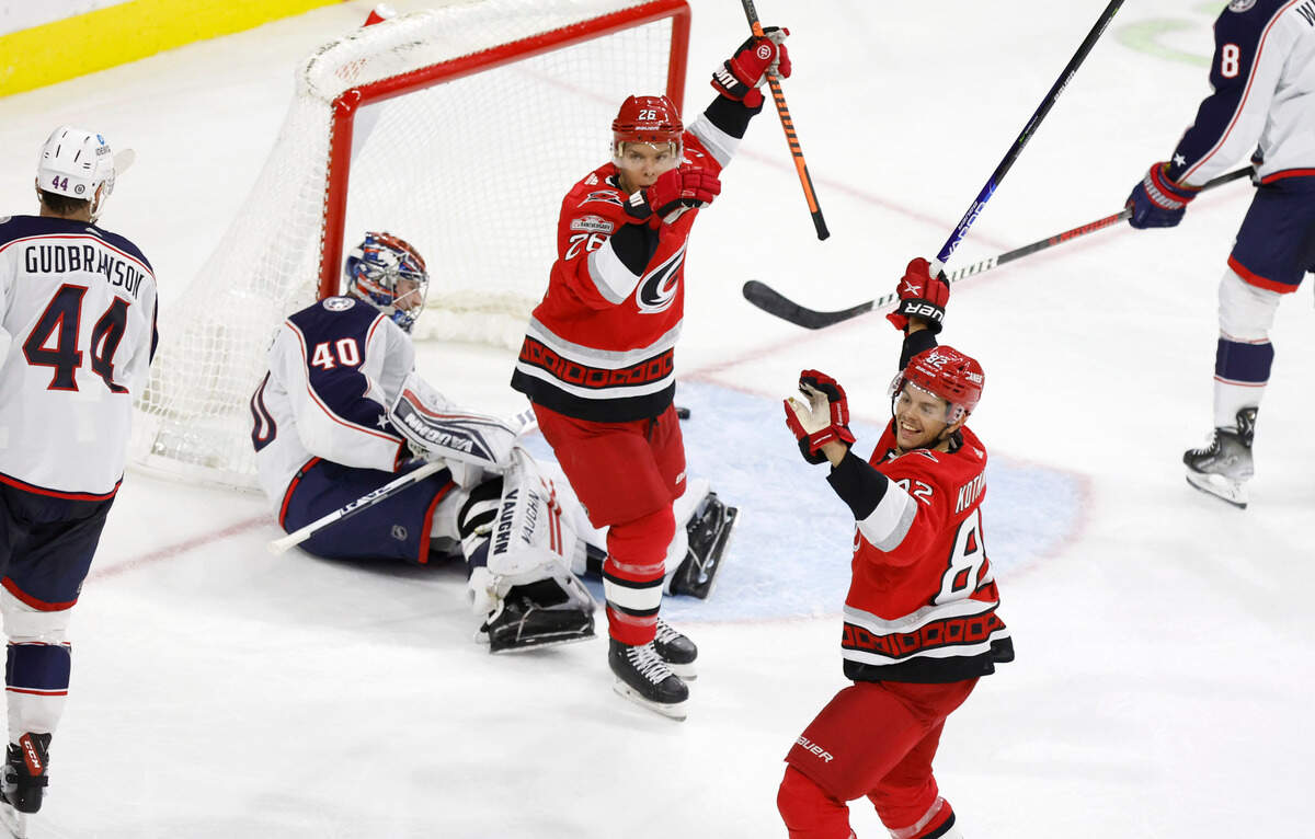 Carolina’s Paul Stastny (26) and Jesperi Kotkaniemi (82) look back at Andrei Svechnikov after he scored during the third period of the Carolina Hurricanes’ 4-1 victory over the Columbus Blue Jackets at PNC Arena in Raleigh, N.C., Wednesday, Oct. 12, 2022.