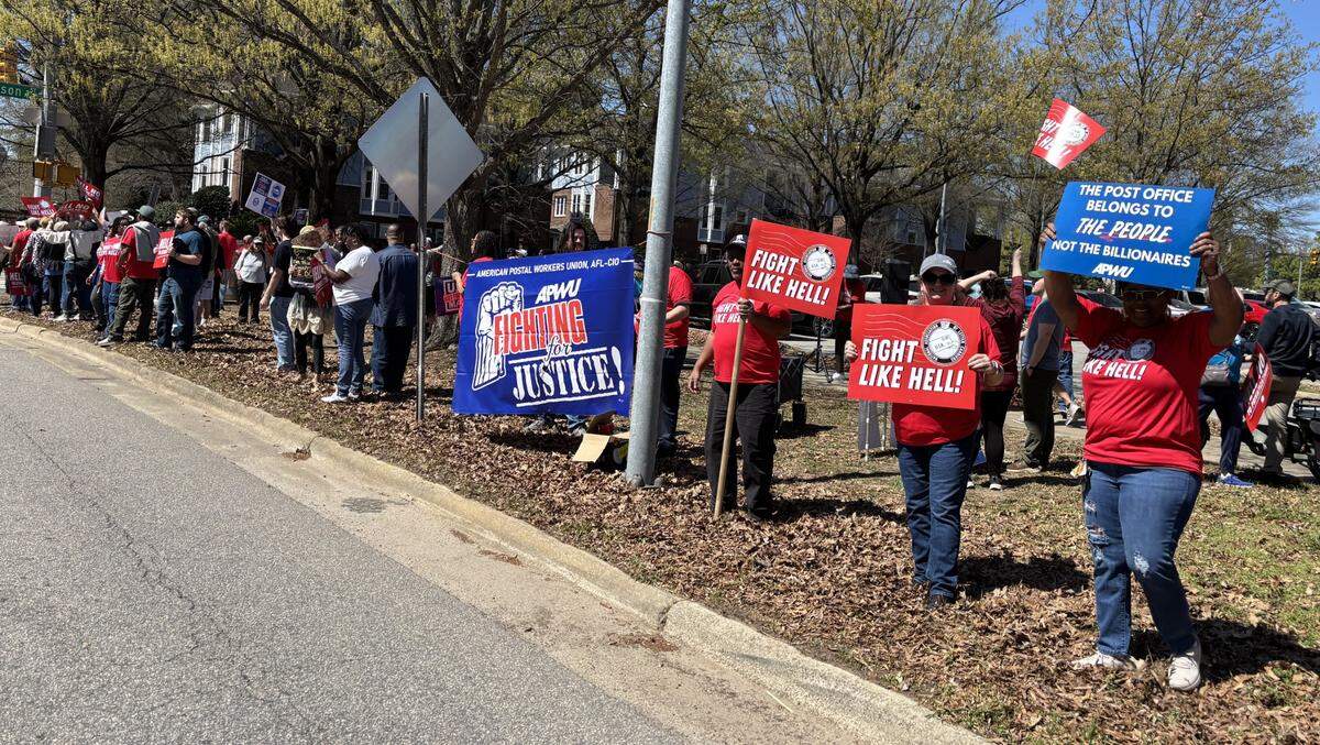 Postal employees and supporters line New Bern Avenue in downtown Raleigh protesting plans to cut or privatize the U.S. Postal Service.
