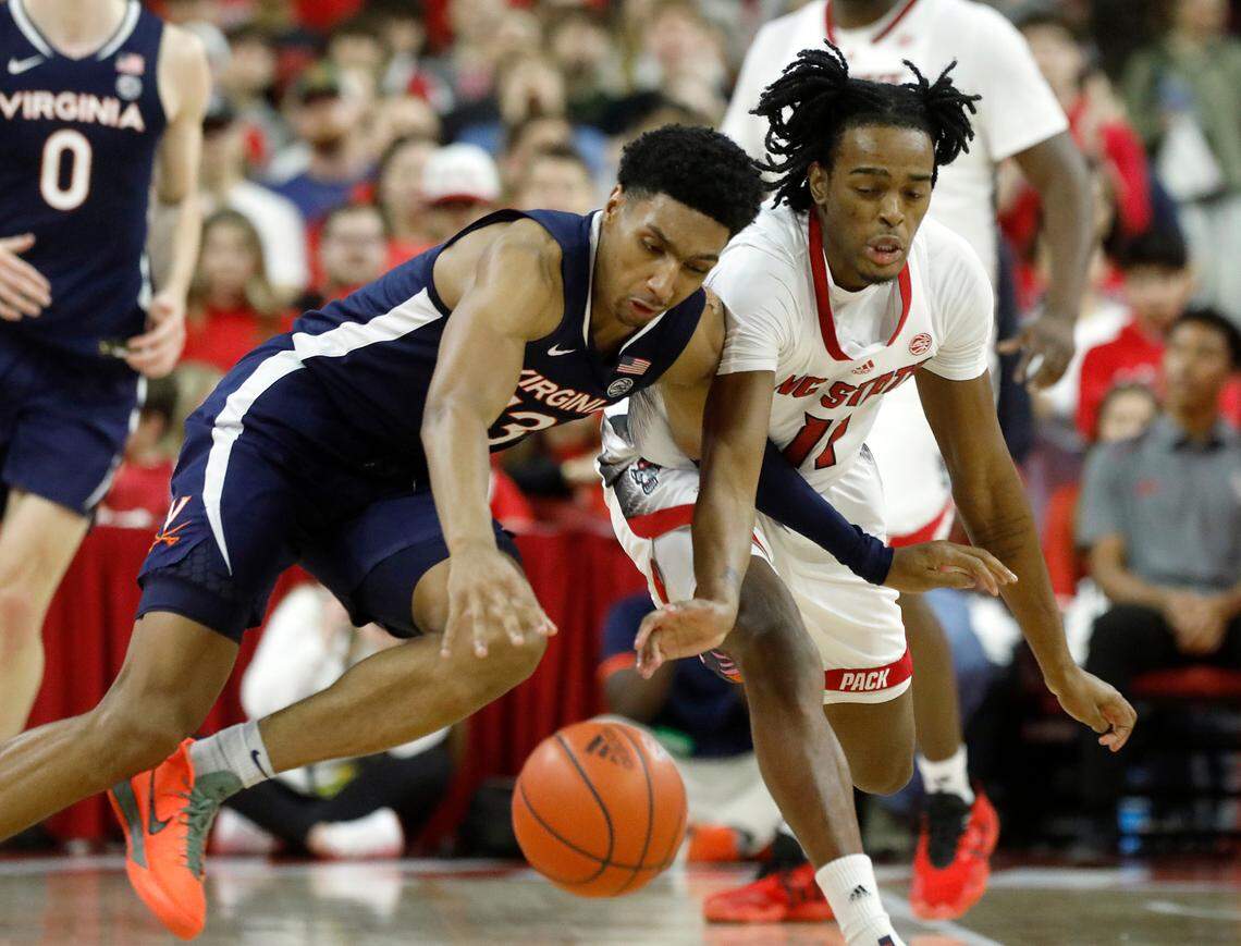N.C. State’s Dennis Parker Jr. pressures Virginia’s Ryan Dunn during the first half of the Wolfpack’s 76-60 win on Saturday, Jan. 6, 2024, at PNC Arena in Raleigh, N.C.