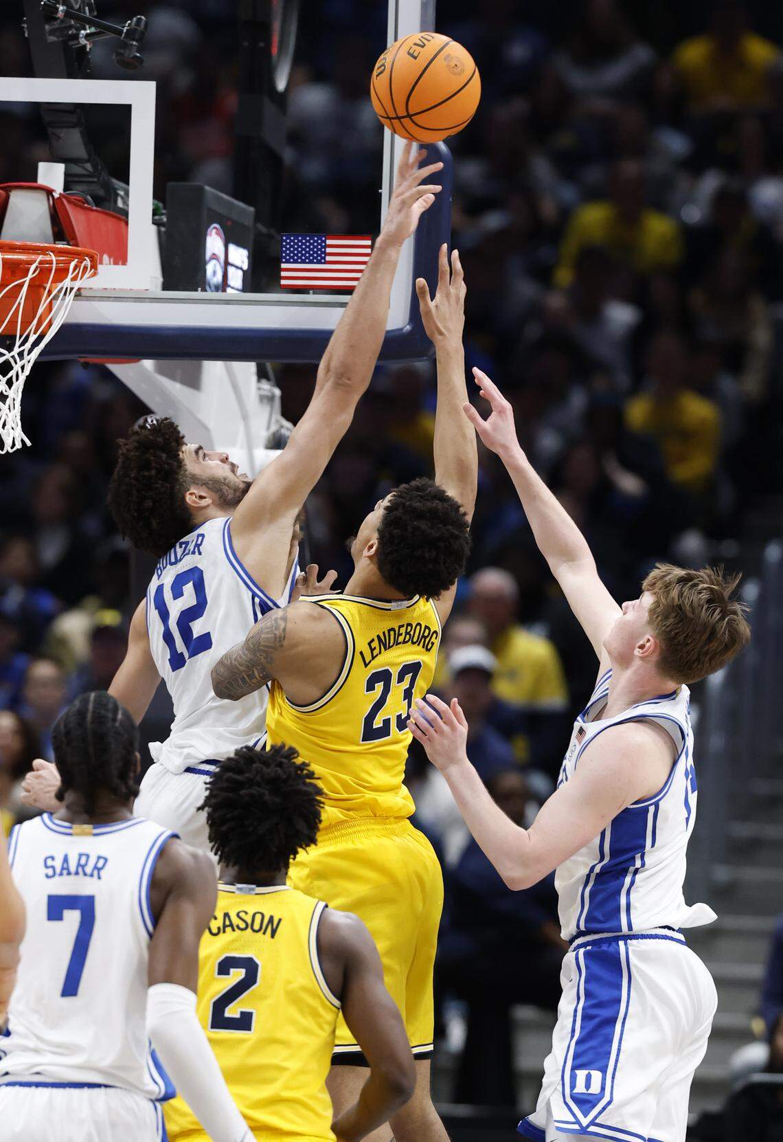 Duke’s Cameron Boozer (12) blocks the shot by Michigan's Yaxel Lendeborg (23) during the second half of Duke’s 68-63 victory over Michigan in the Capital Showcase at Capital One Arena in Washington, D.C., Saturday, Feb. 21, 2026.