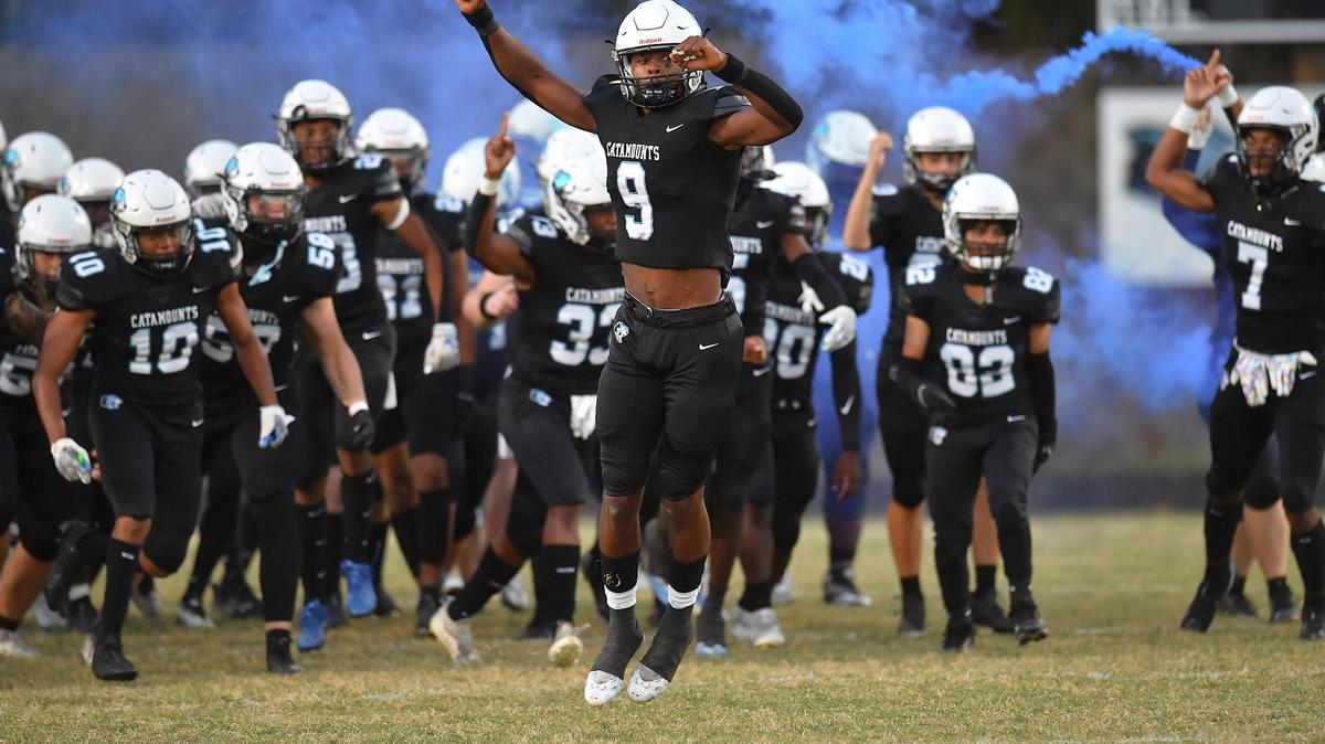 Panther Creek’s Tyler Thompson (9) leads his team onto the field before their game against Green Hope. The Green Hope Falcons and the Panther Creek Catamounts met in a football game in Raleigh, N.C. on September 23, 2022.