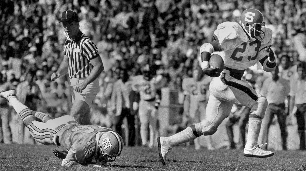 N.C. State’s Ted Brown leaves UNC defender Bernie Menapace behind as he scores his second of three touchdowns against UNC Oct. 23, 1978.