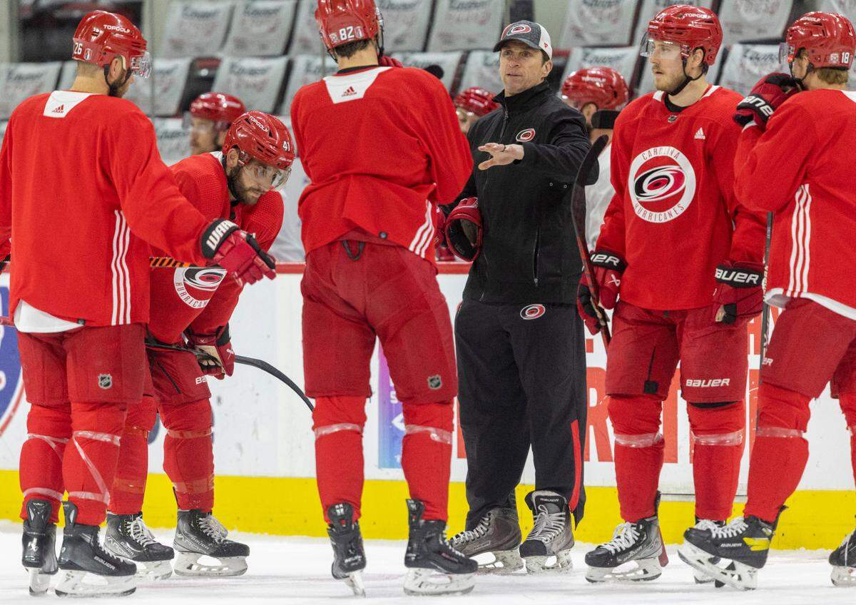 Carolina Hurricanes coach Rod Brind’Amour talks with Jesperi Kotkaniemi (82) during practice on Wednesday, May 17, 2023, as they prepare for Game 1 of the Eastern Conference Finals against the Florida Panthers at PNC Arena in Raleigh, N.C.