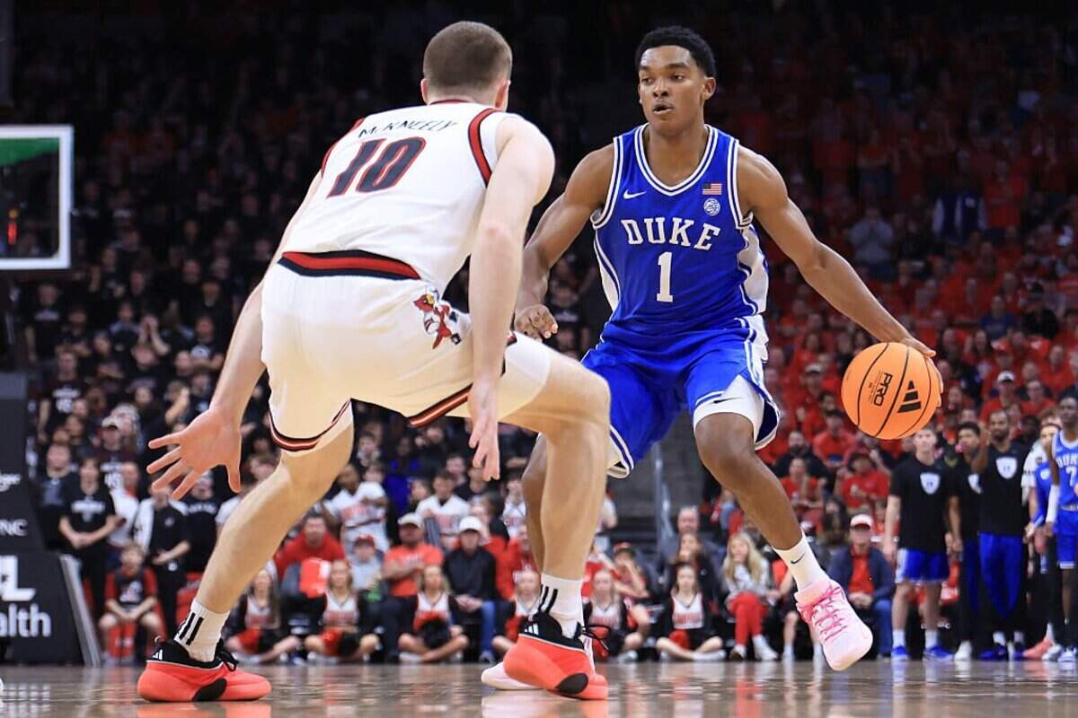 Caleb Foster (1) of the Duke Blue Devils brings the ball up the court against Isaac McKneely during the first half at KFC YUM! Center on January 6, 2026 in Louisville, Kentucky.