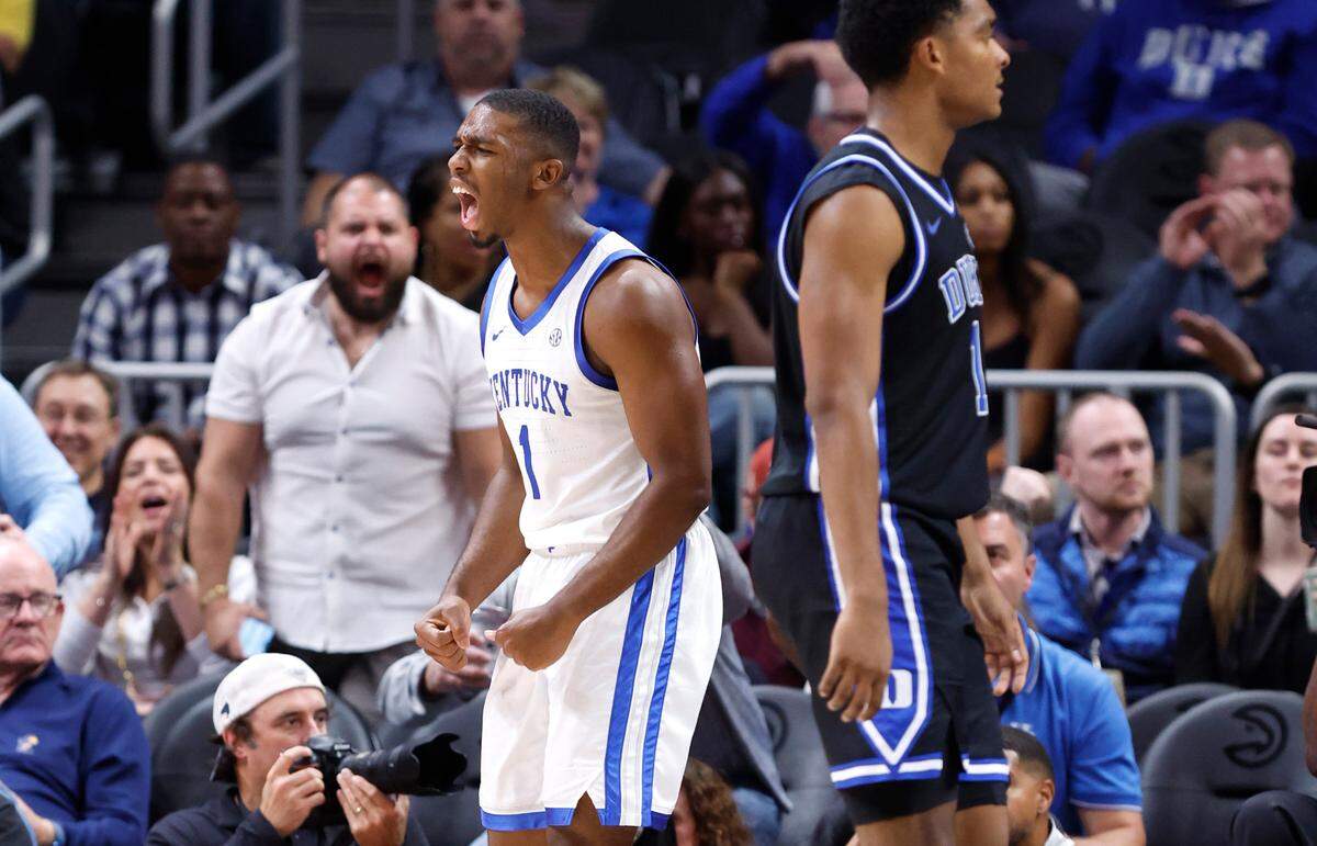 Kentucky’s Lamont Butler (1) celebrates making the basket while being fouled during the second half of Kentucky’s 77-72 victory over Duke in the State Farm Champions Classic in Atlanta, Ga., Tuesday, Nov. 12, 2024. Duke’s Caleb Foster (1) is to the right.