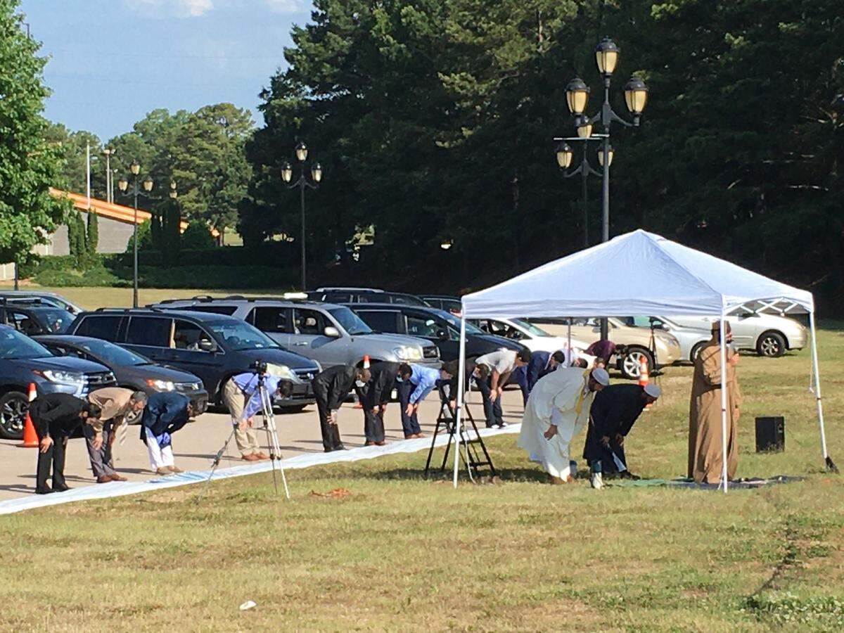 A celebration Sunday, May 24, 2020, in Raleigh, North Carolina, marks the end of Ramadan. The Islamic Association of Raleigh held two drive-in communal prayers at the North Carolina Fairgrounds. The celebration typically brings Muslims together shoulder-to-shoulder in mosques. The Islamic Association of Raleigh adapted to keep worshipers at safe distances from one another, to keep the coronavirus from spreading.