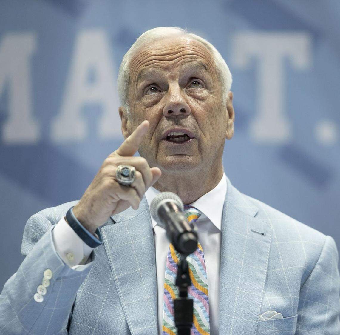 North Carolina coach Roy Williams points to the rafters of the Smith Center acknowledging the players he has coached and the three National Championships he won as he announced his retirement on Thursday, April 1, 2021 in Chapel Hill, N.C. Williams has coached for 33 seasons, the last 18 at North Carolina.
